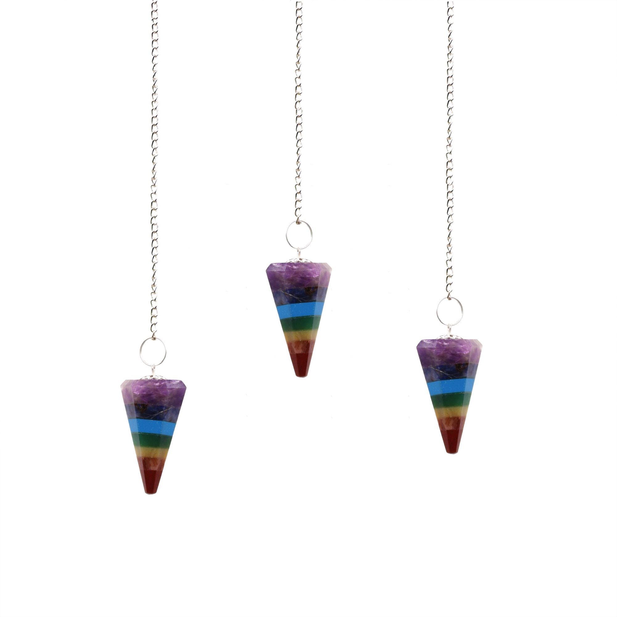 Three rainbow-colored pendulums on white background