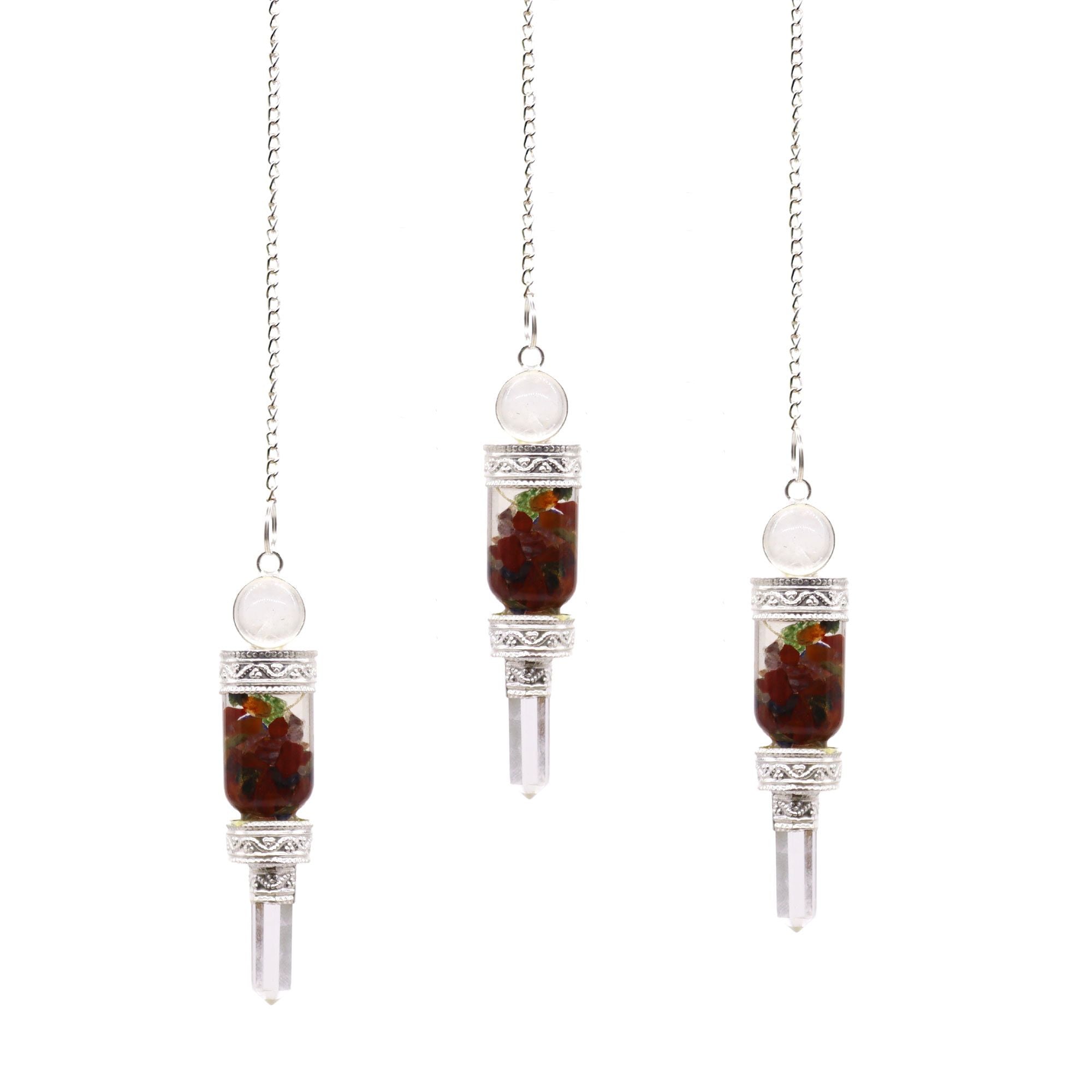 Three hanging crystal pendulums with red stones on a white background