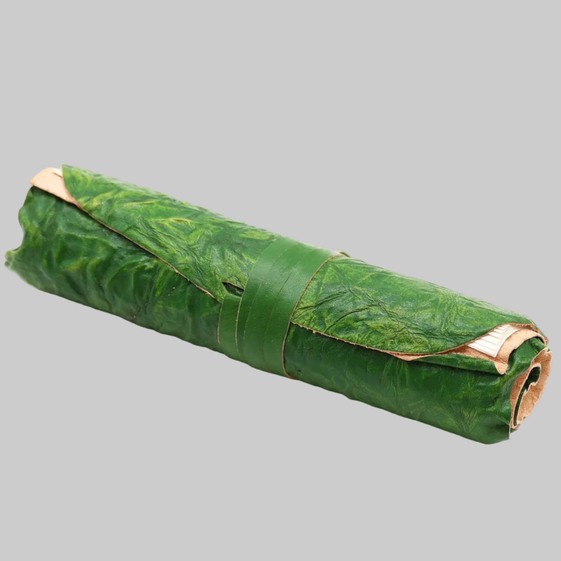 Roll of green leaves on a white background