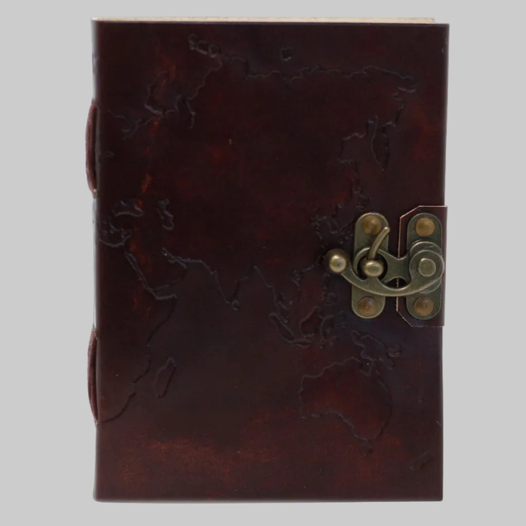 Brown leather notebook with embossed design and brass latch on a white background
