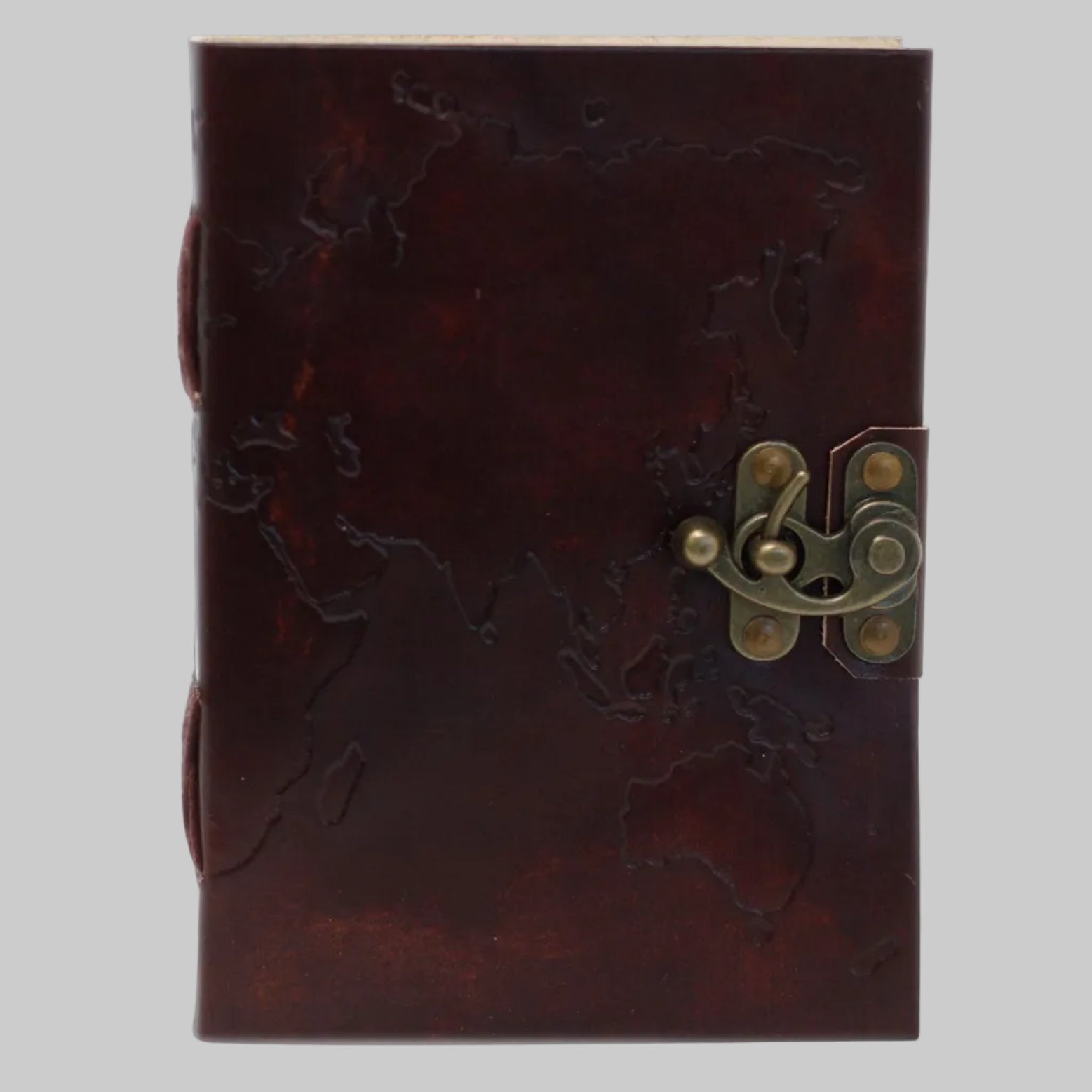 Brown leather notebook with embossed design and brass latch on a white background