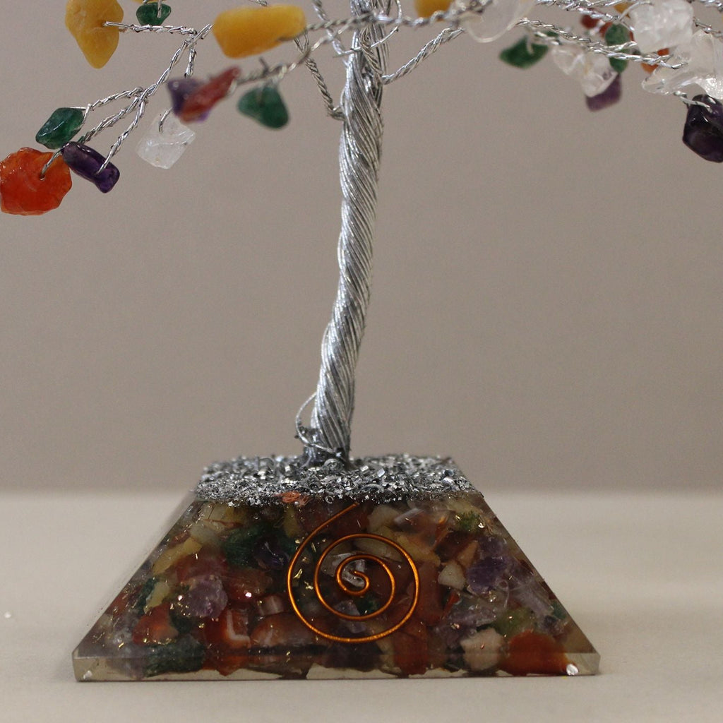 Crystal tree with colorful stones on a pyramid base with a spiral design.