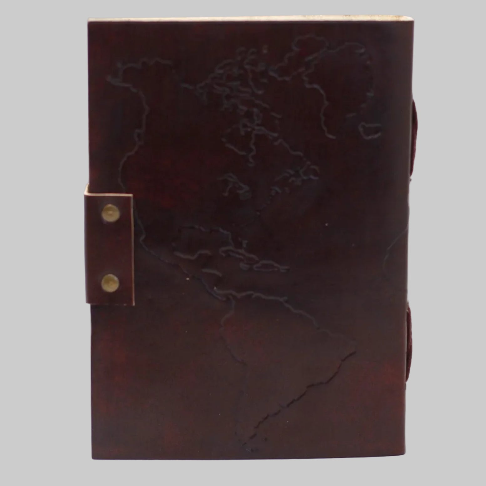 Brown leather notebook with embossed design on a white background