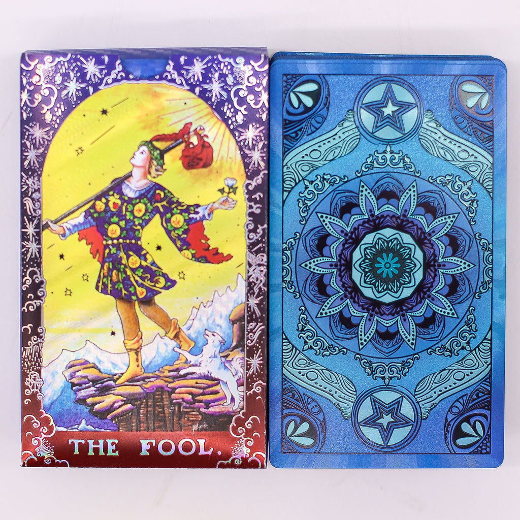 Two tarot cards, one colorful with 'The Fool' illustration and the other blue with star and mandala design.