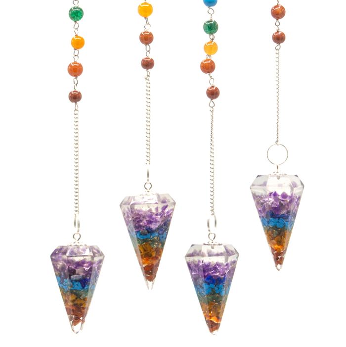 Set of four chakra pendulums with colorful beads on a white background