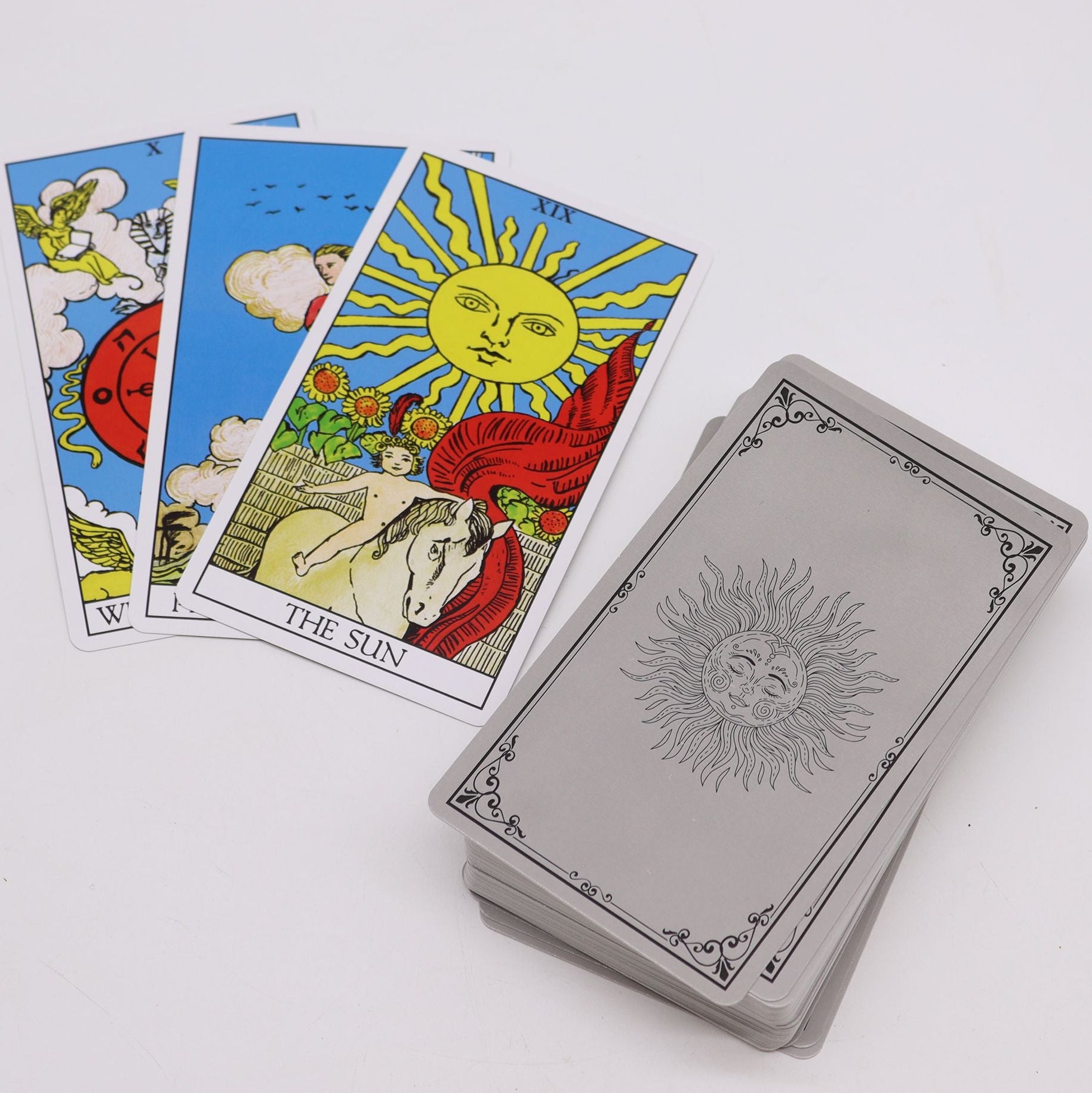 Tarot cards with 'The Sun' card on a white background