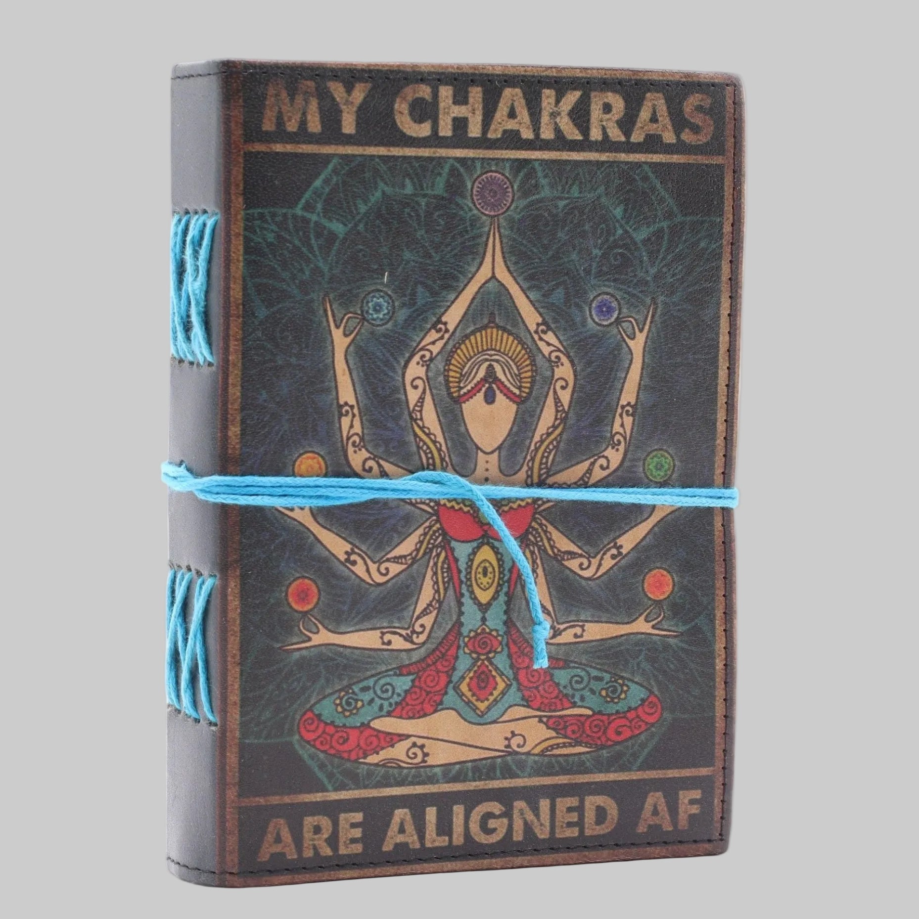Journal with chakra design and text 'My Chakras Are Aligned AF' on a white background
