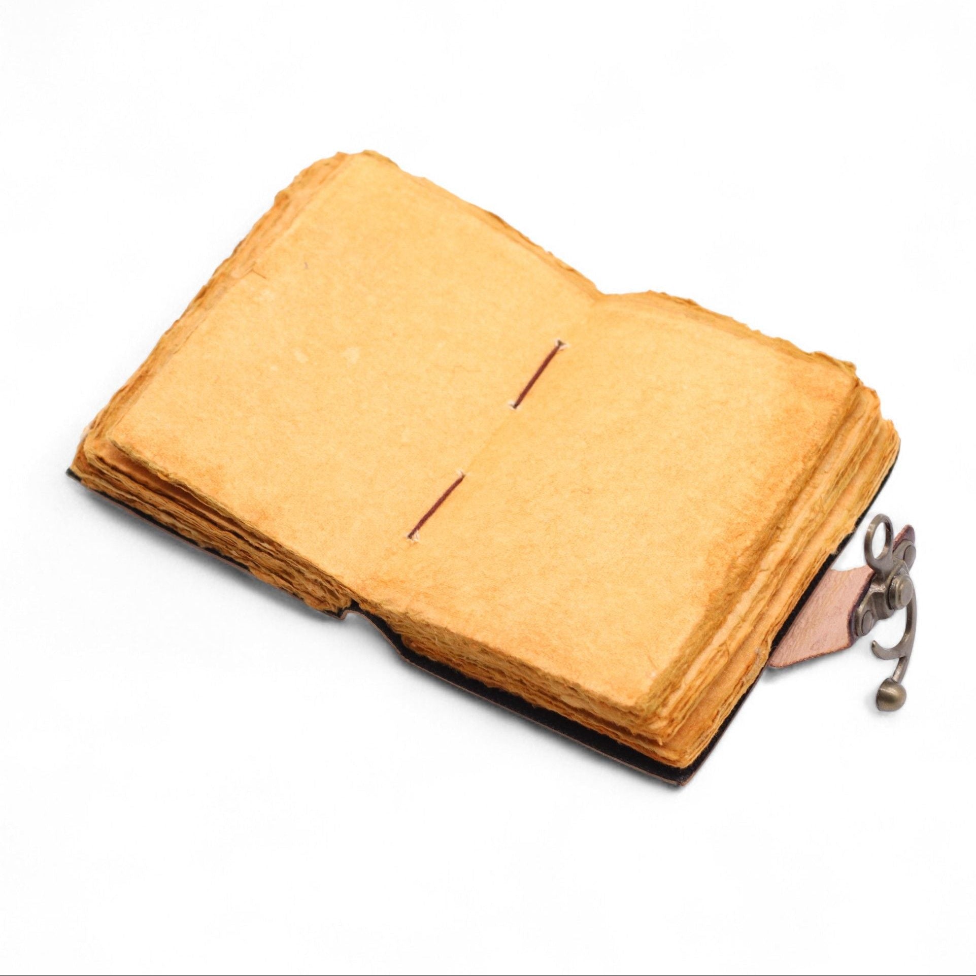 Vintage-style leather-bound notebook with a key attached on a white background