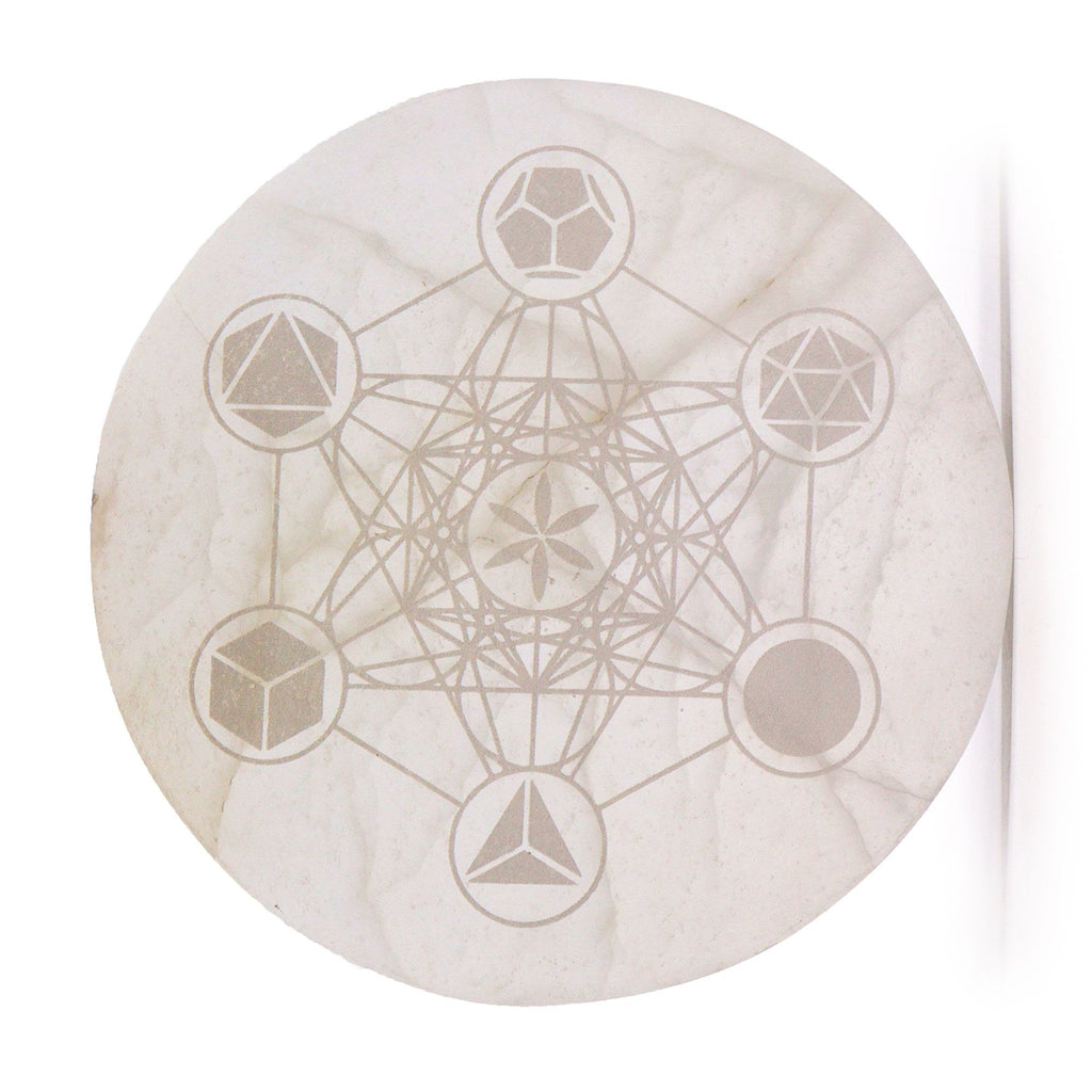 Decorative stone with geometric etchings on a white background