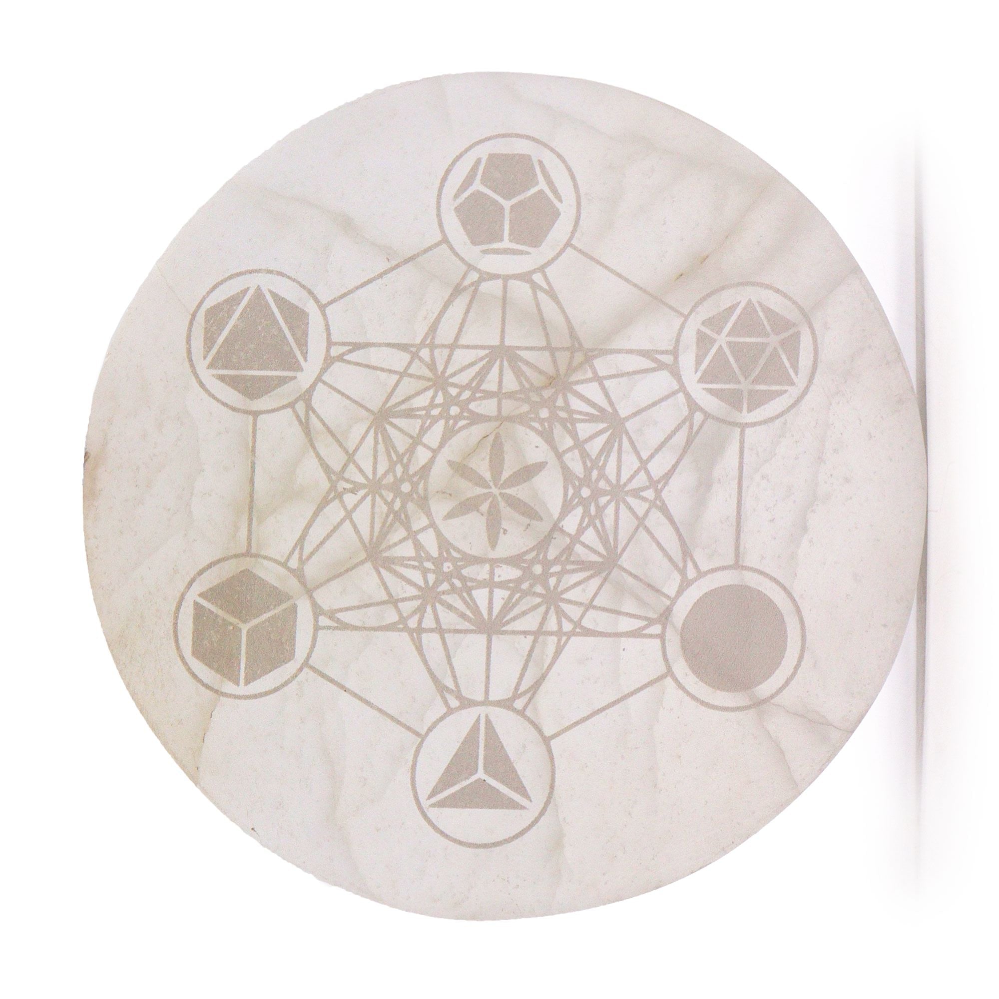Decorative stone with geometric etchings on a white background