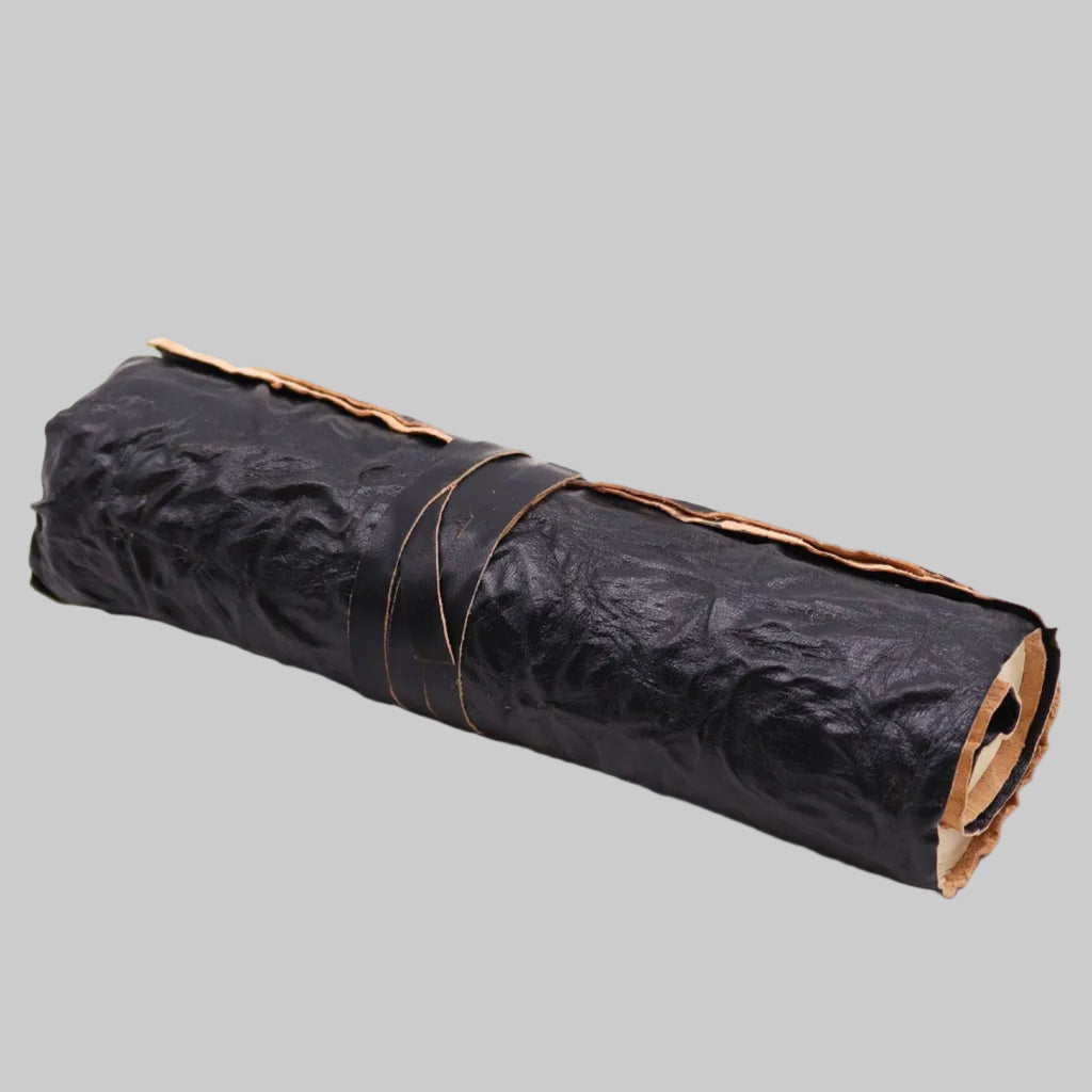 Rolled black paper with brown tape on a white background
