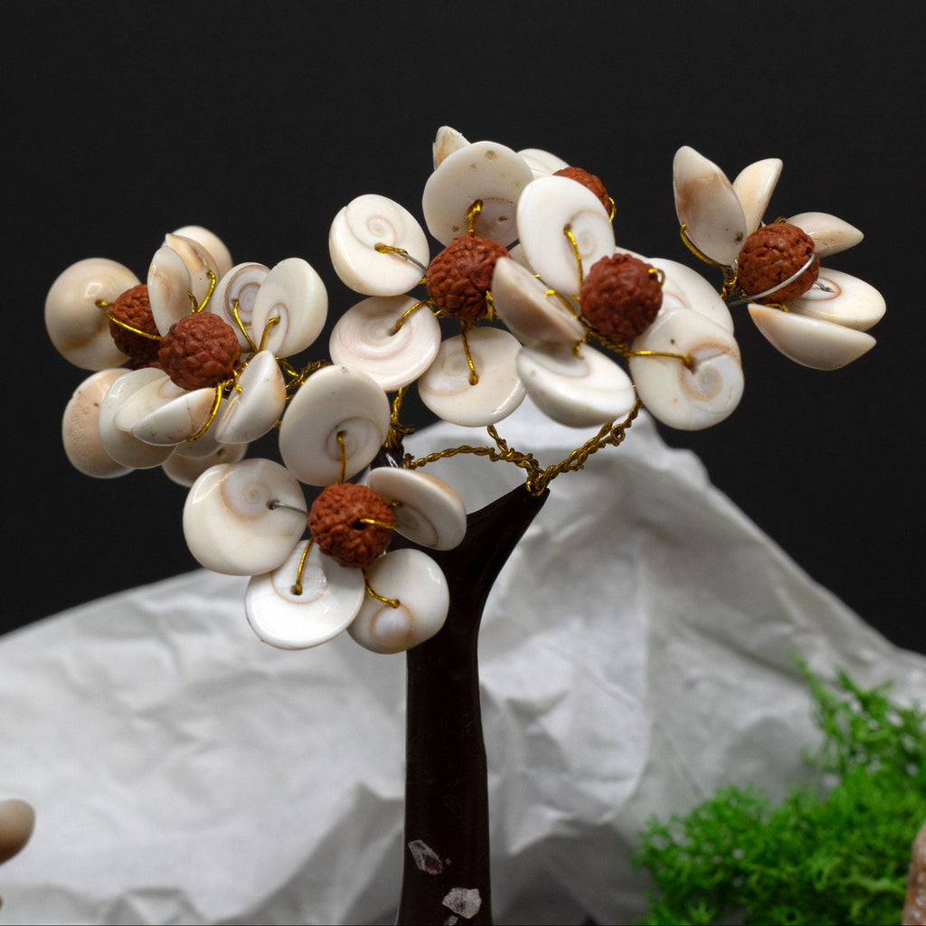 Decorative tree with white flowers and brown berries on a black background