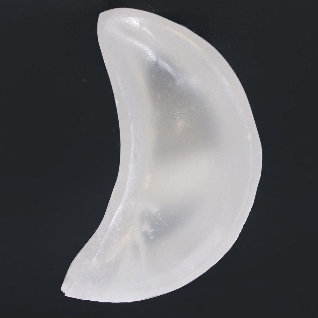 Clear silicone breast form on a black background