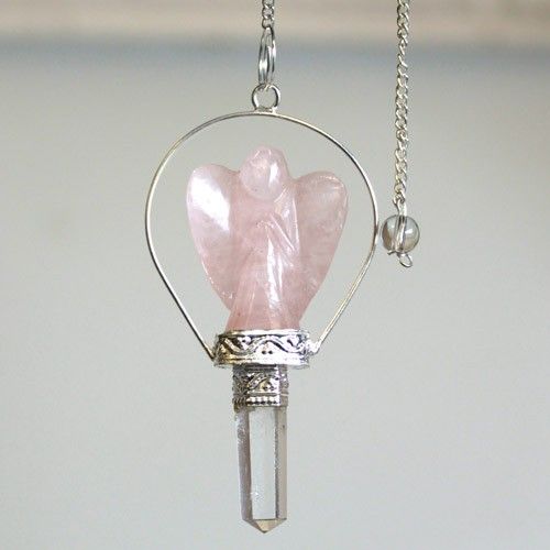 Crystal pendant with pink angel figure and silver chain on a light gray background
