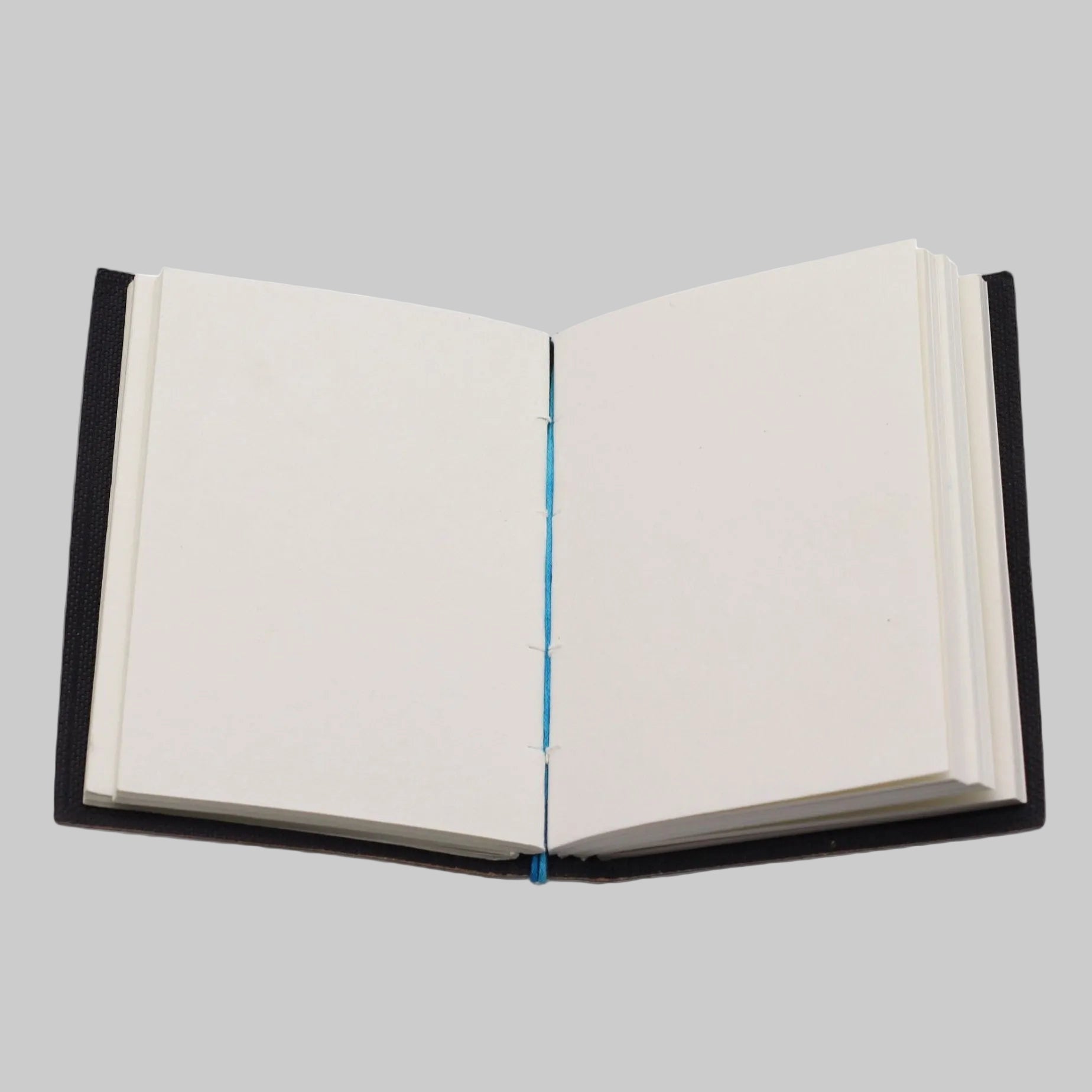 Open notebook with black leather binding on a white background