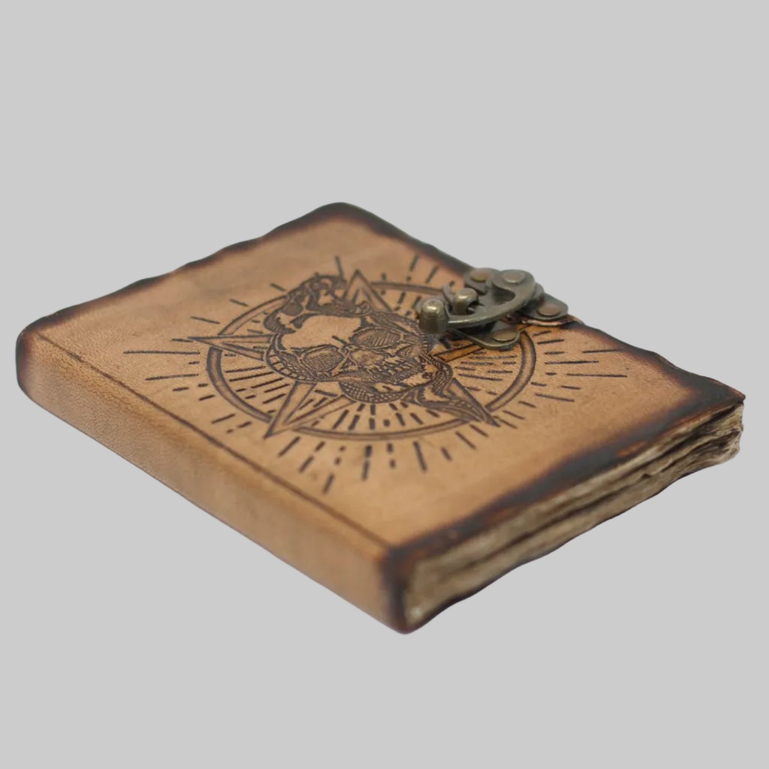 Wooden journal with engraved design and metal clasp on a white background