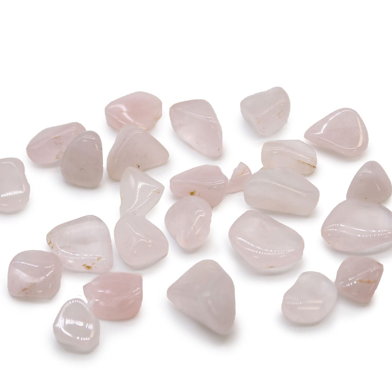 Collection of rose quartz stones on a white background