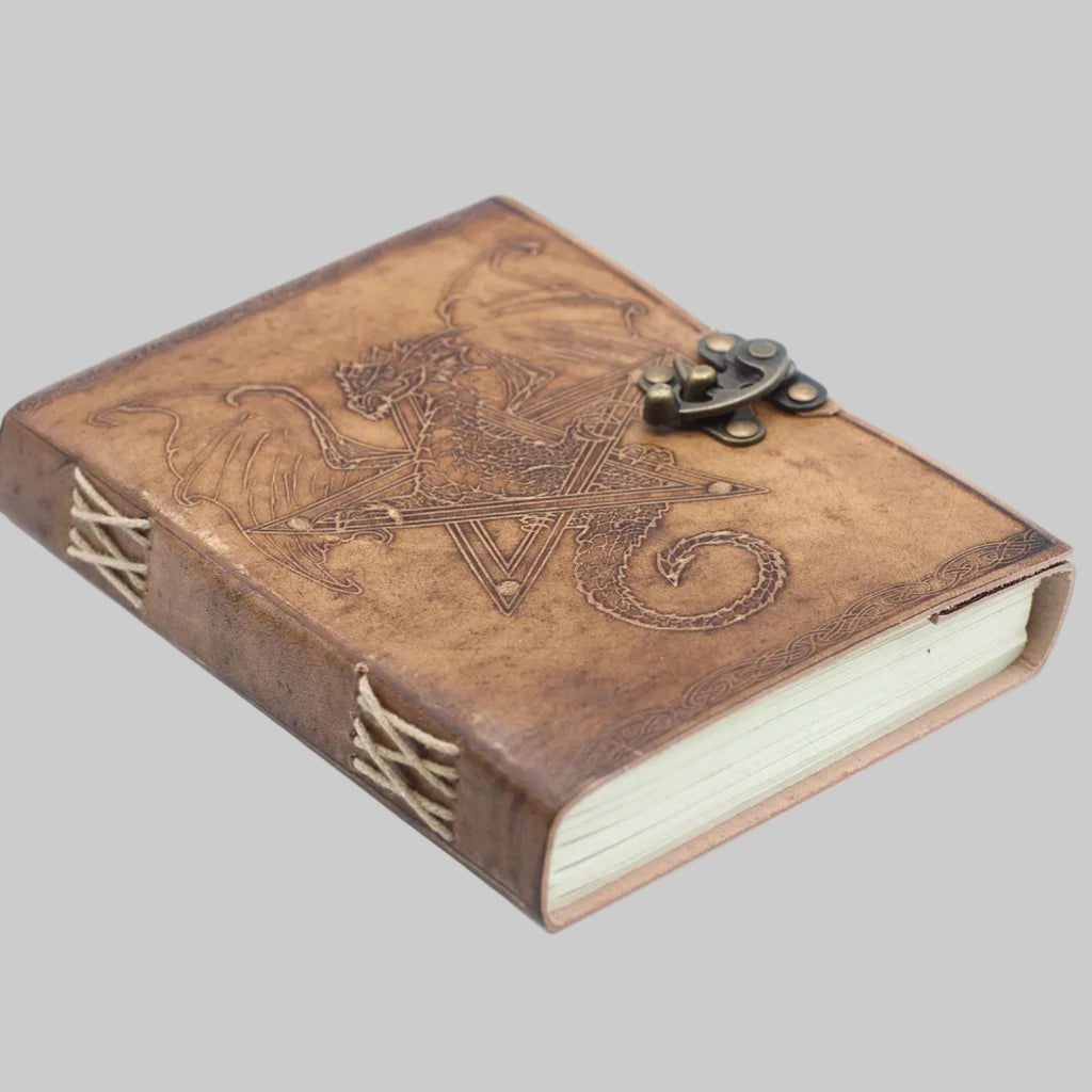 Brown leather journal with embossed design and latch on a white background