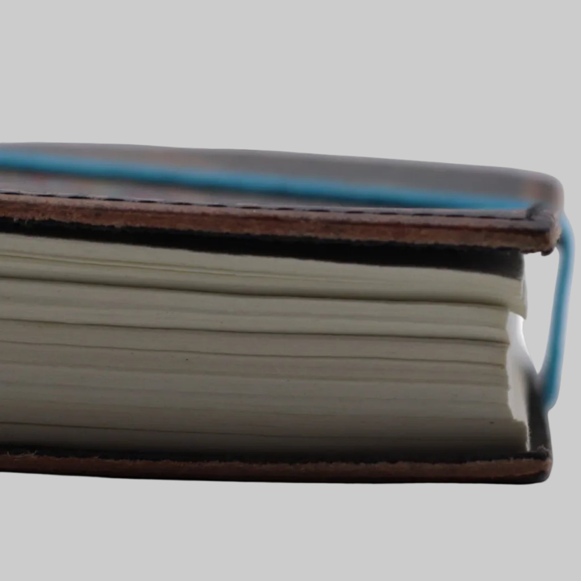Close-up of a leather-bound notebook on a white background