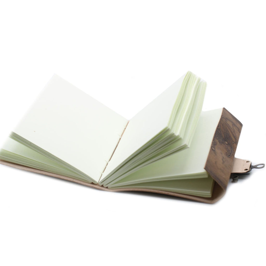 Open notebook with wooden cover on a white background