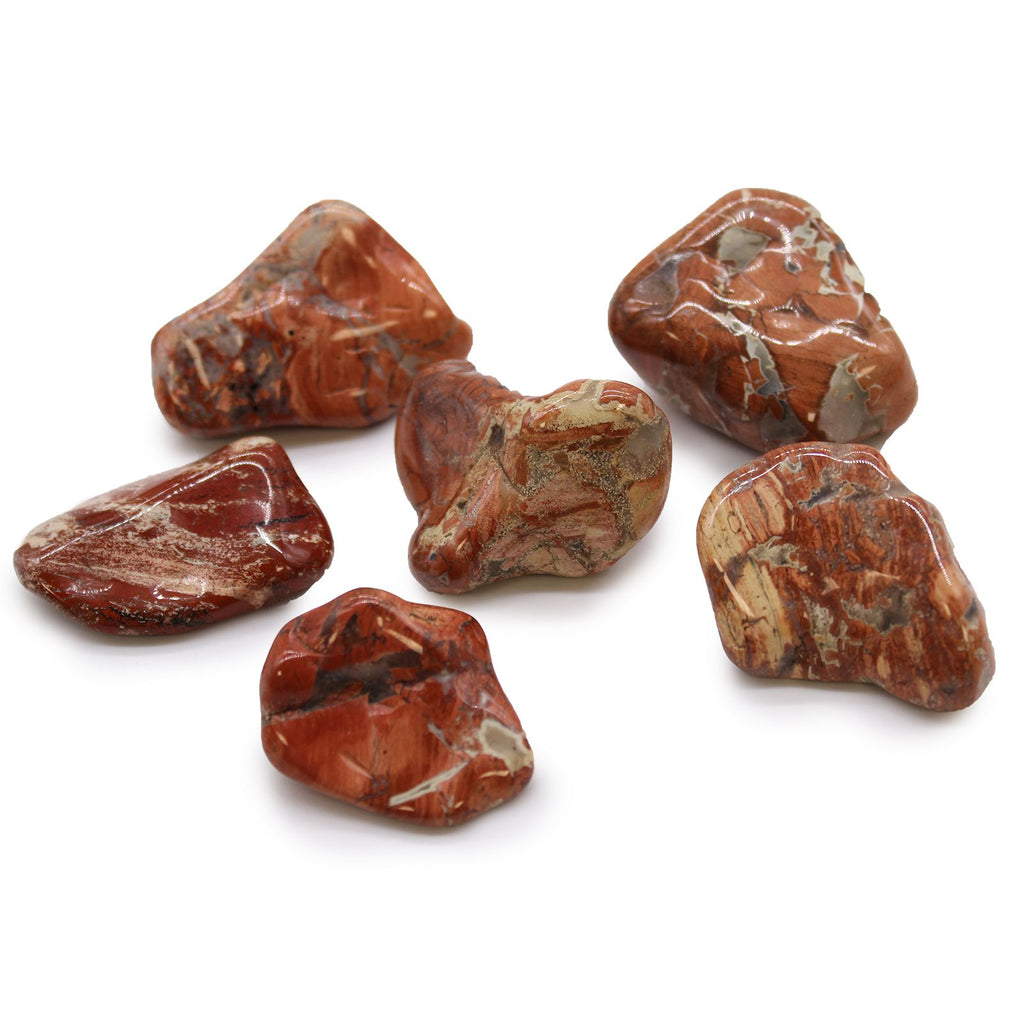Six brown and red marbled stones on a white background