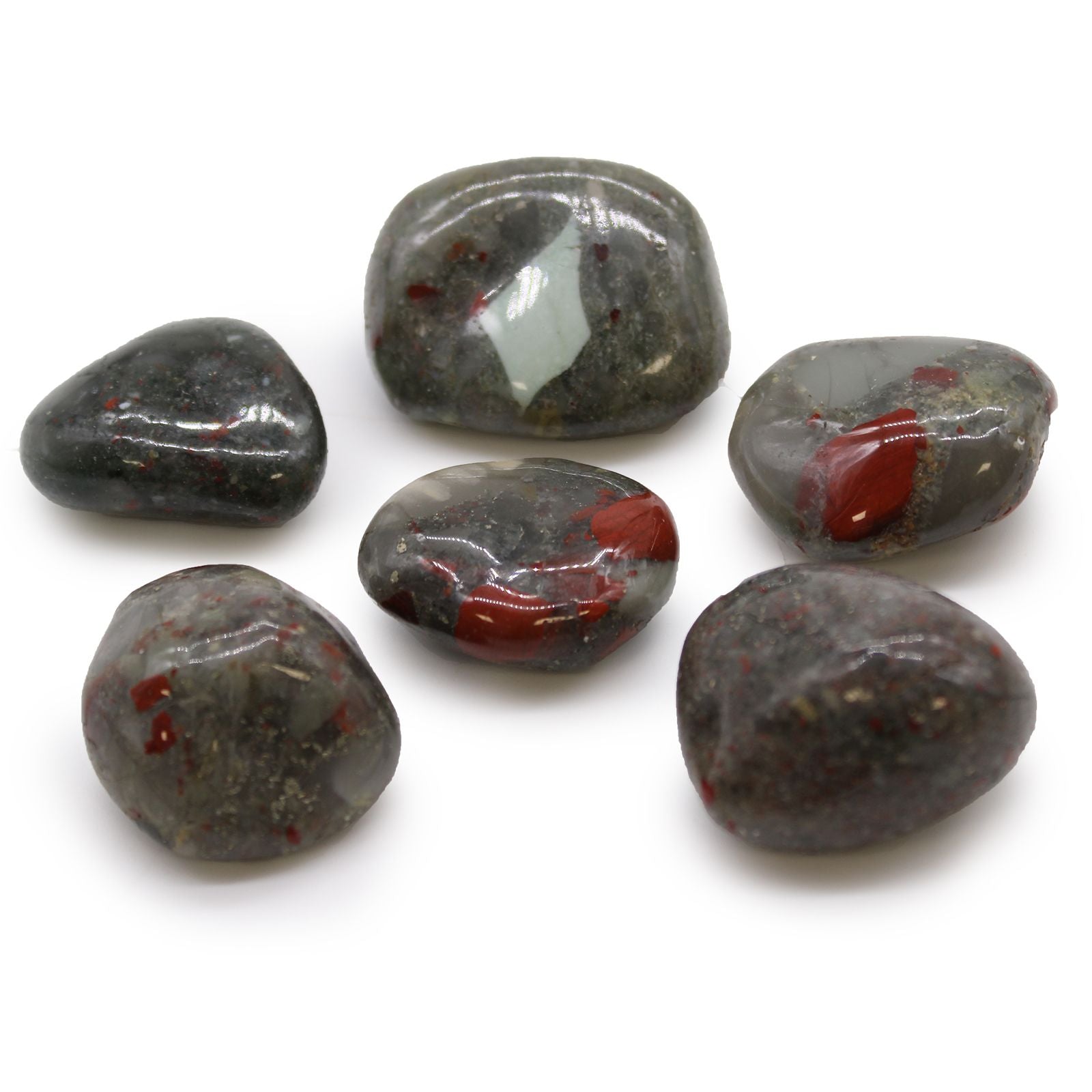 Six polished stones with red and white inclusions on a white background