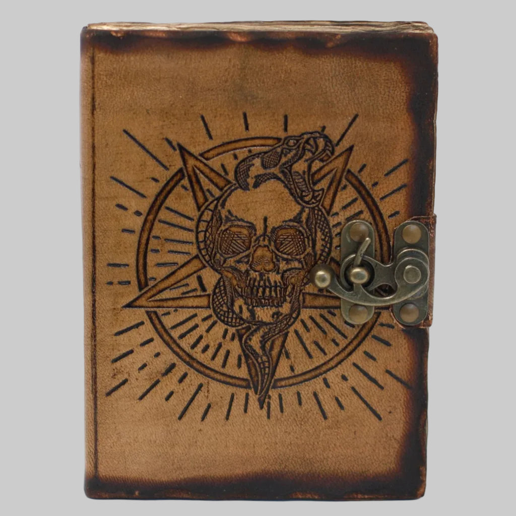 Brown leather journal with skull and snake design on a white background