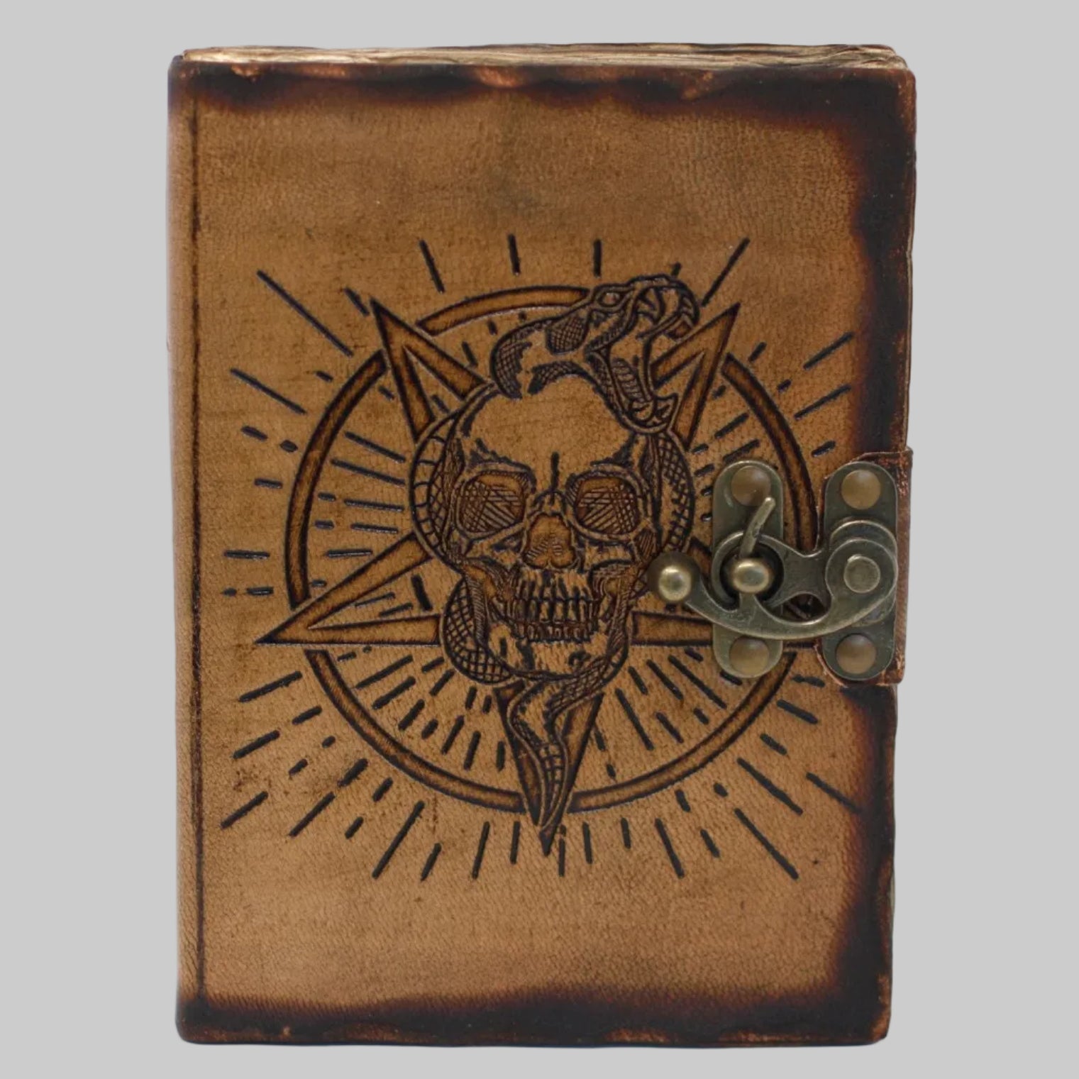 Brown leather journal with skull and snake design on a white background