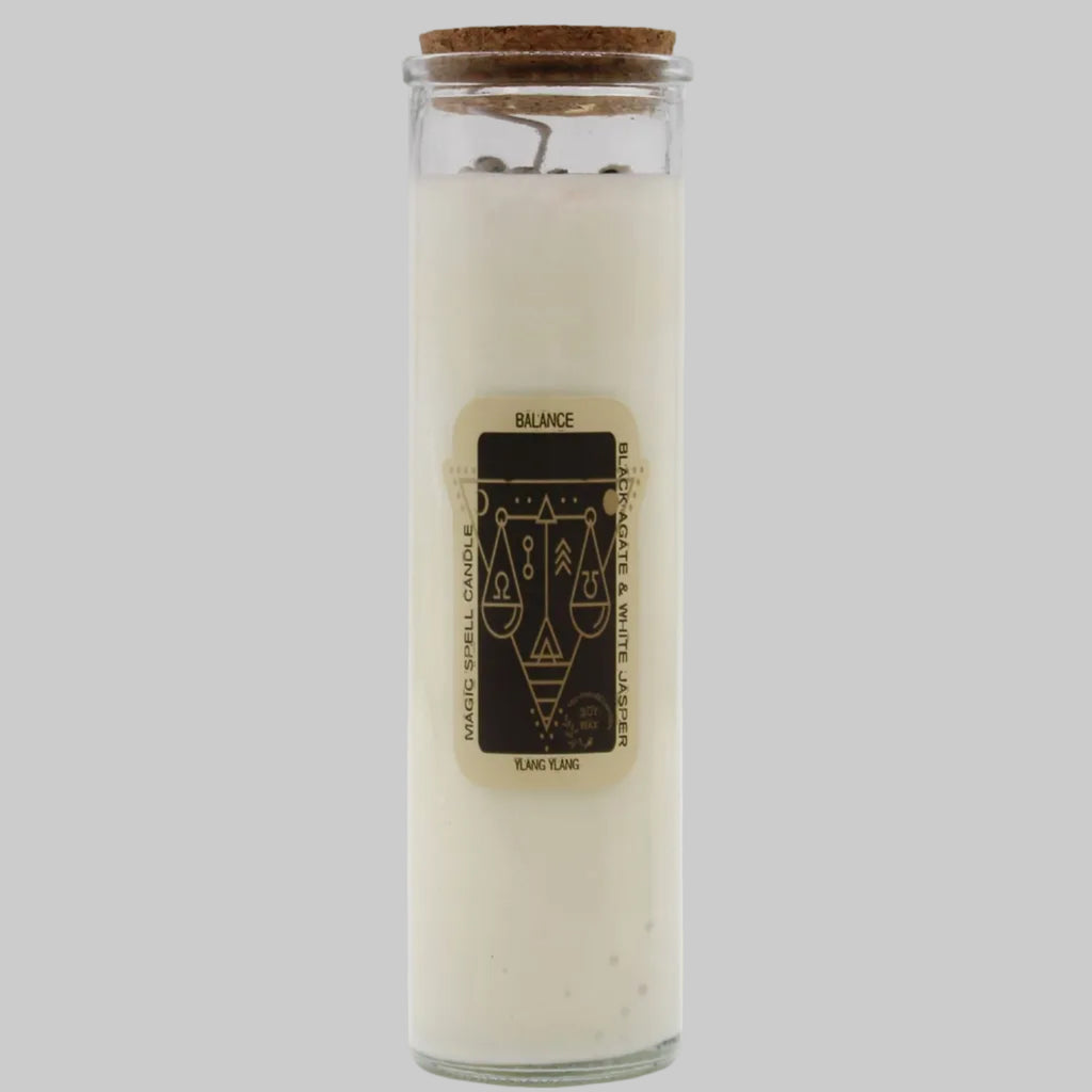 Glass candle with cork lid and label on a white background