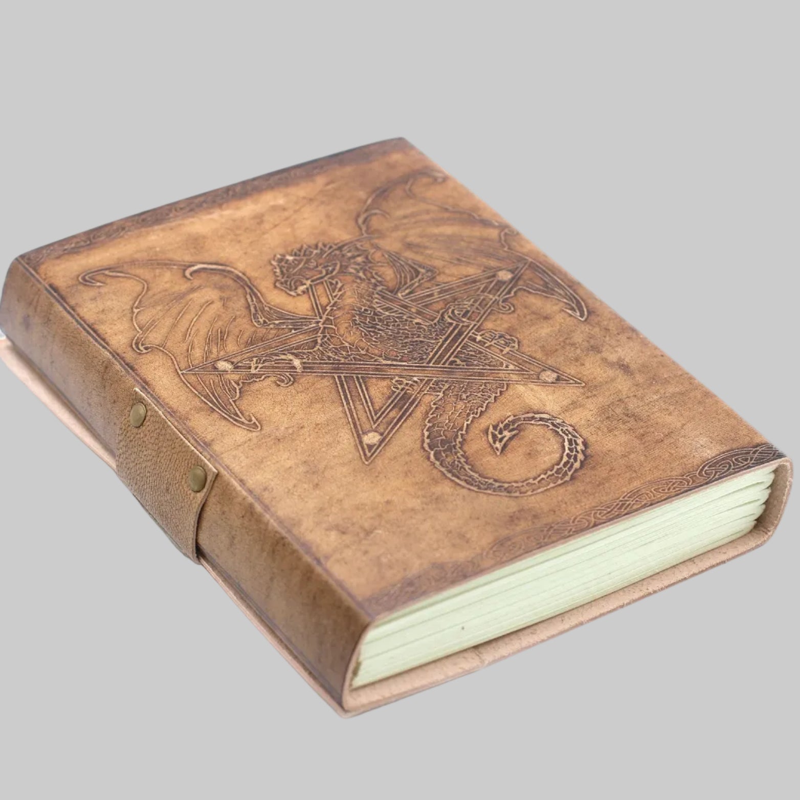 Brown leather-bound book with embossed design on a white background