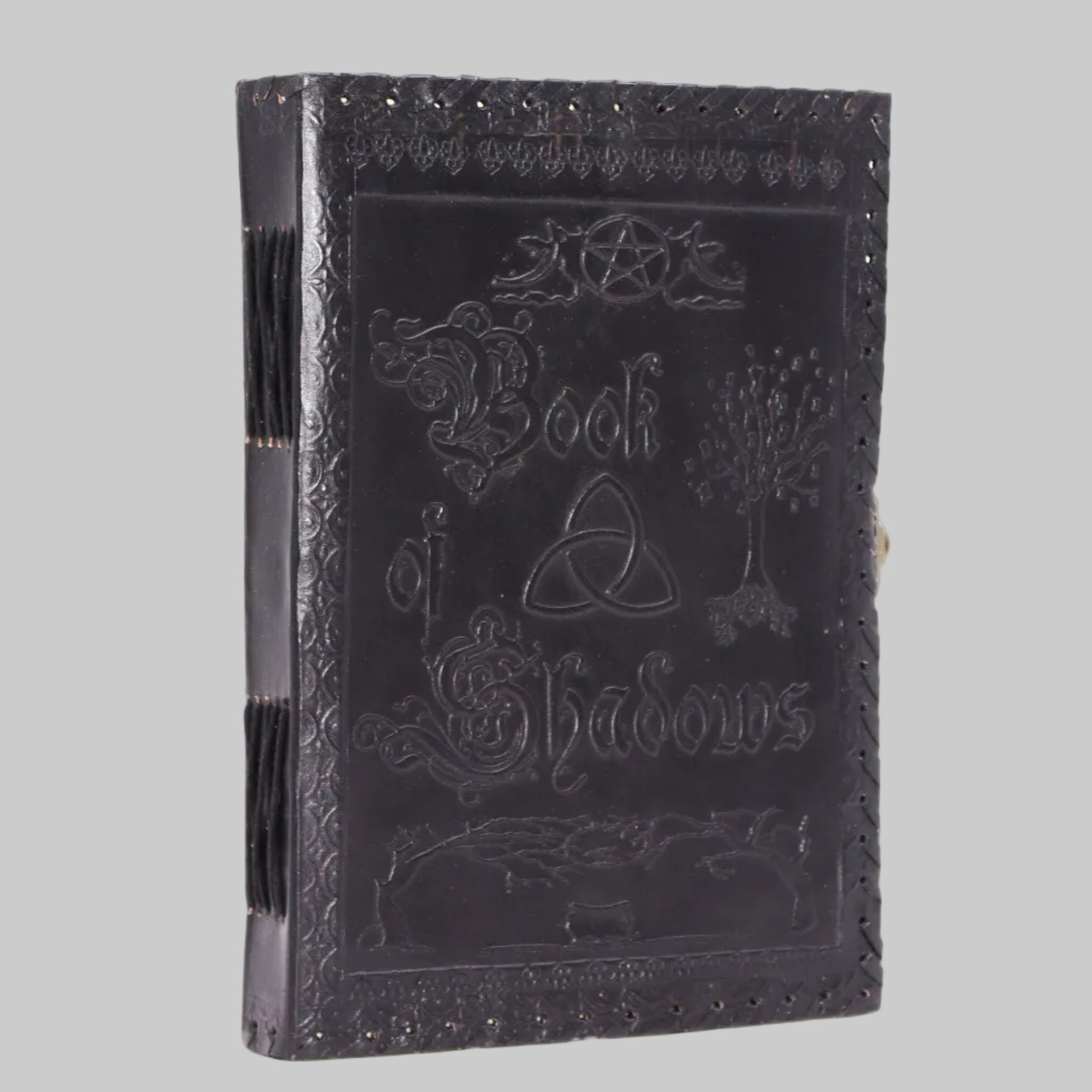 Black leather-bound book titled 'Book of Shadows' with embossed designs on a white background