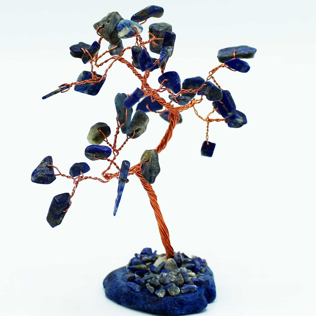 Crystal tree sculpture with blue stones on a white background