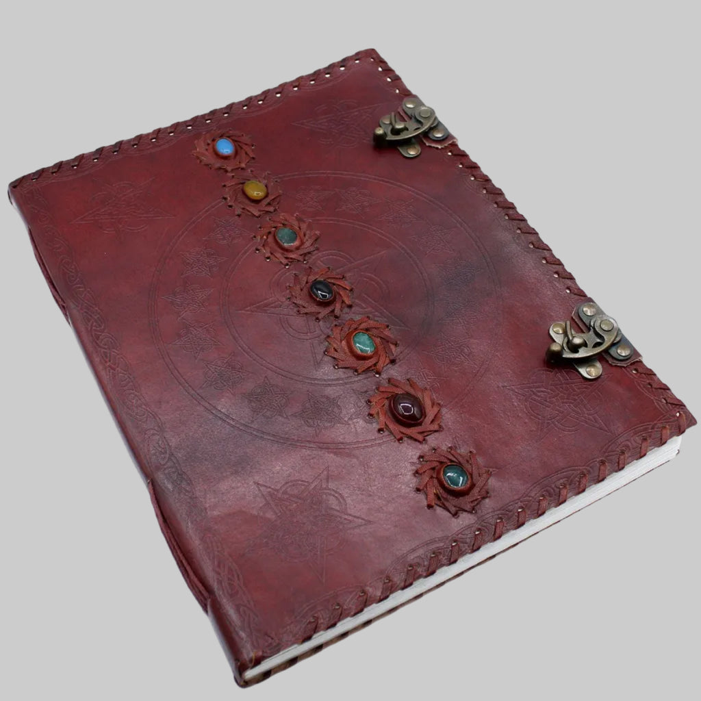 Red leather journal with decorative elements on a white background