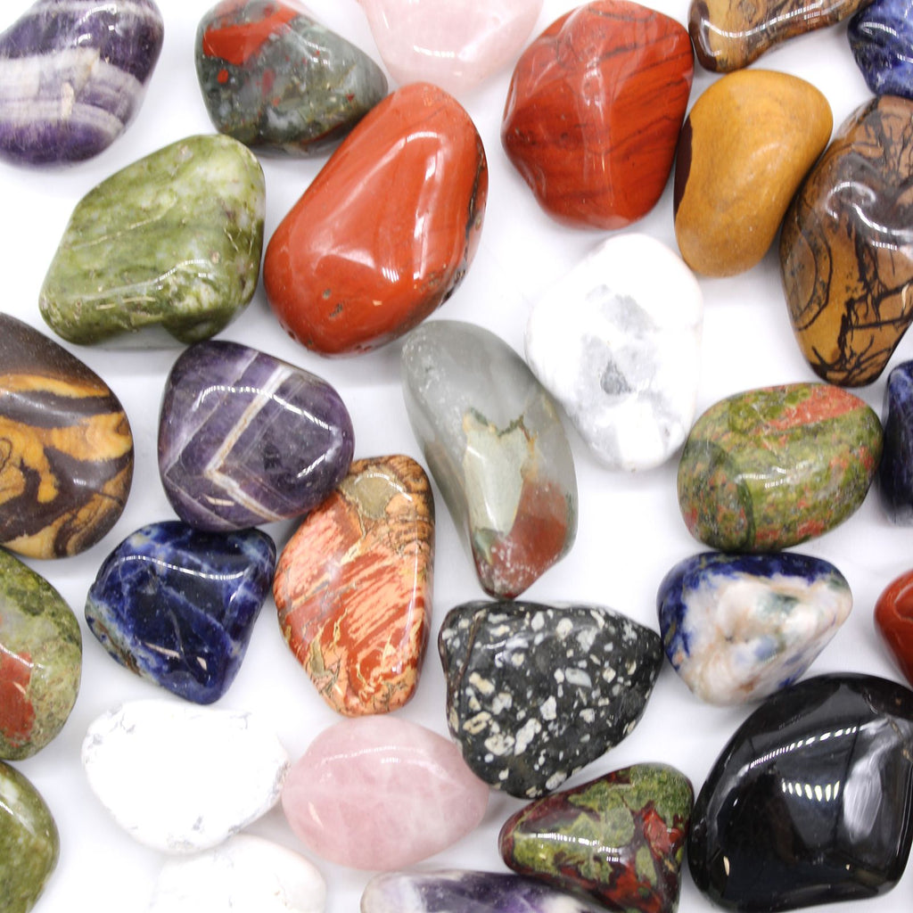 Assorted colorful stones on a white background