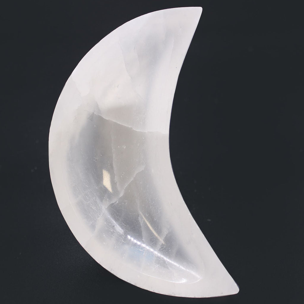 Crystal moon-shaped object on a black background