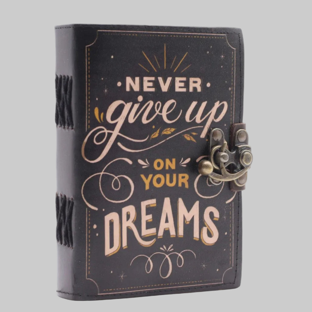 Decorative notebook with 'Never give up on your dreams' text on a white background