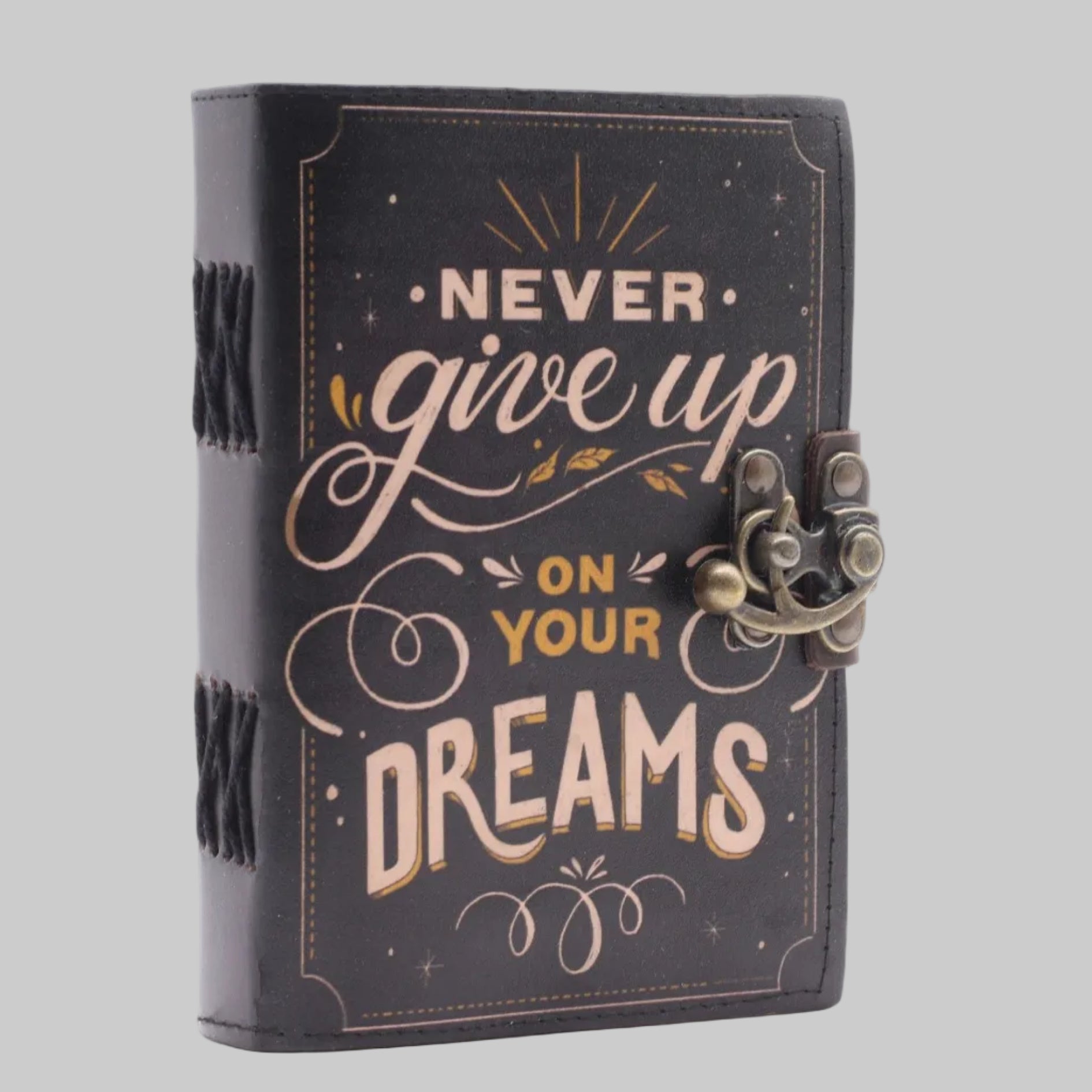 Decorative notebook with 'Never give up on your dreams' text on a white background