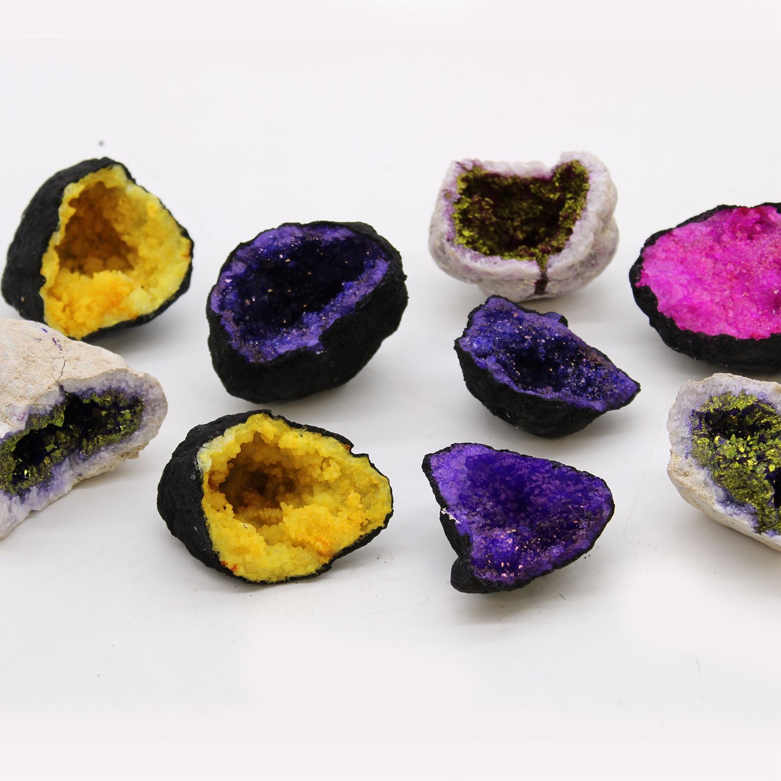 Geode-like rocks with colorful interior patterns on a white background