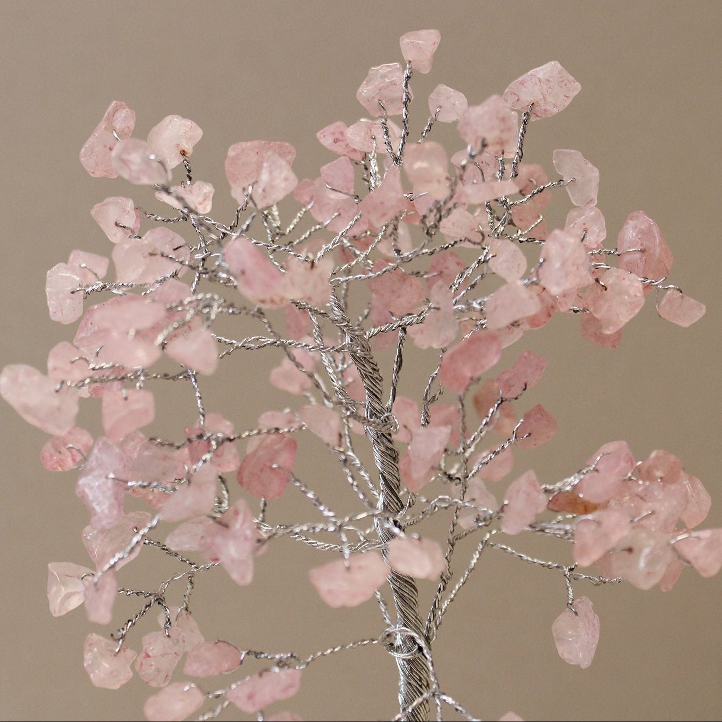 Decorative tree with pink stones on a beige background