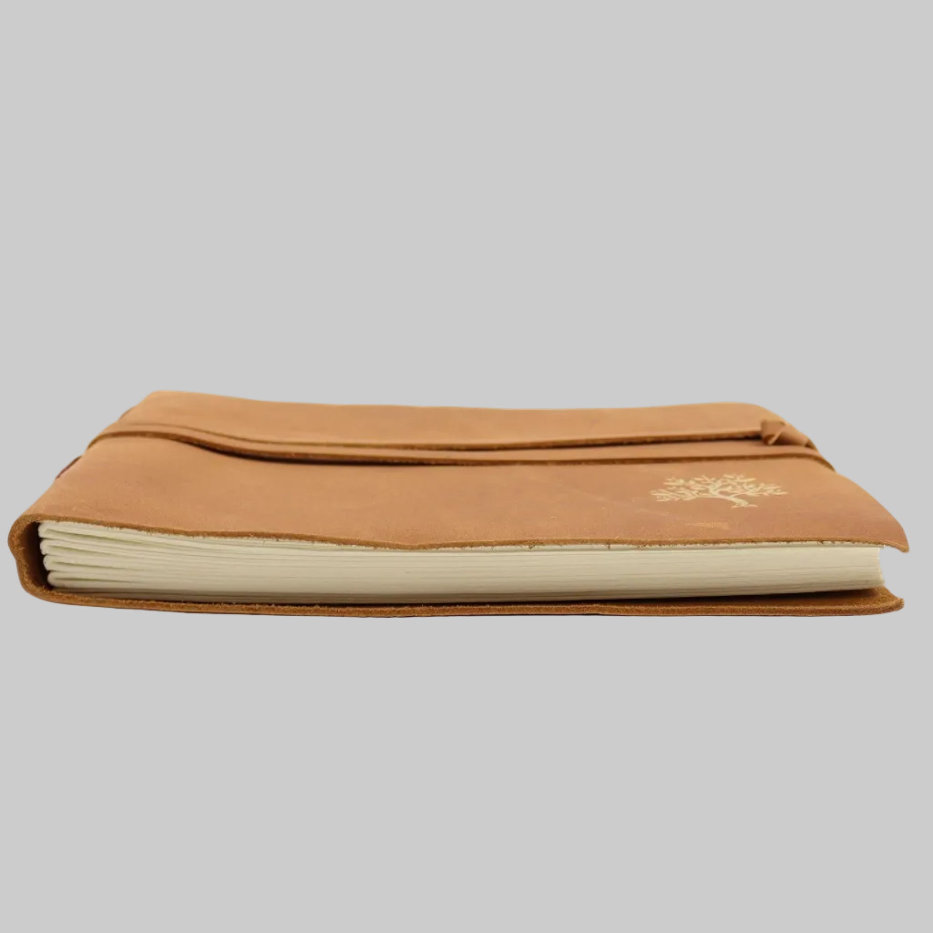 Tan leather notebook with a visible brand logo on a white background