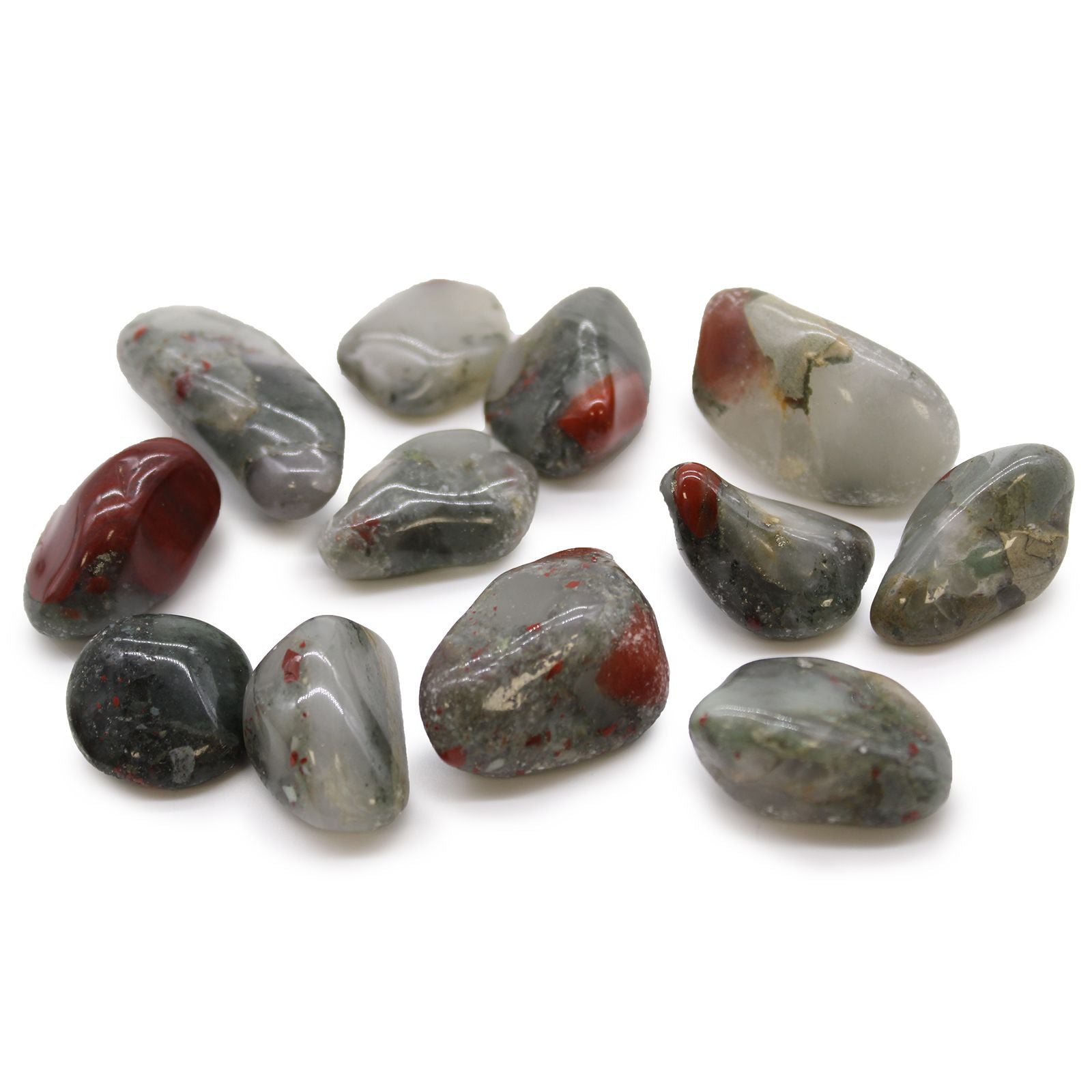 Collection of polished gemstones with red and gray hues on a white background