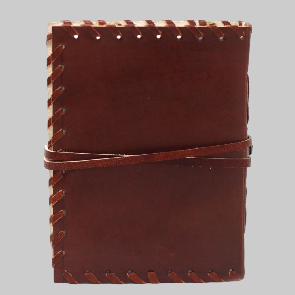Brown leather notebook with visible stitching on a white background
