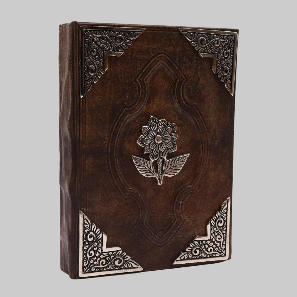 Decorative leather-bound book with floral embossing on a white background