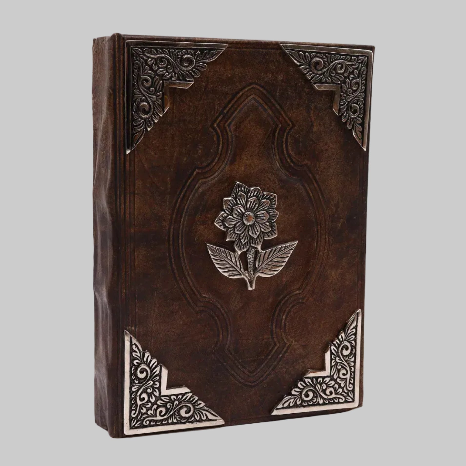 Decorative leather-bound book with floral embossing on a white background