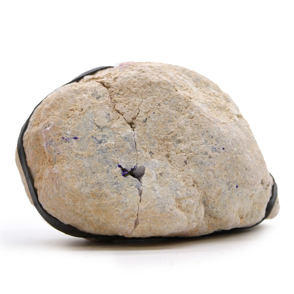 Round beige stone with black edges on a white background