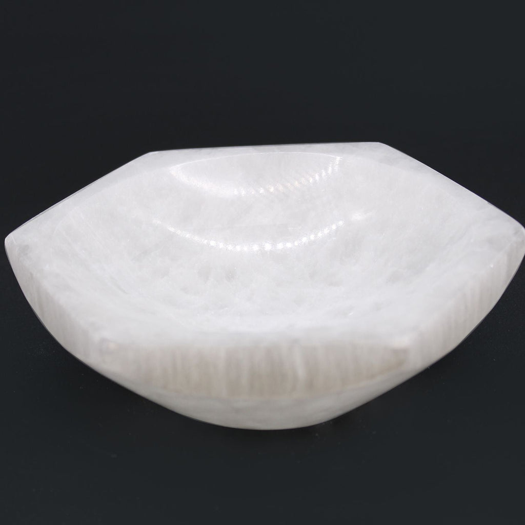White stone with a textured surface on a black background