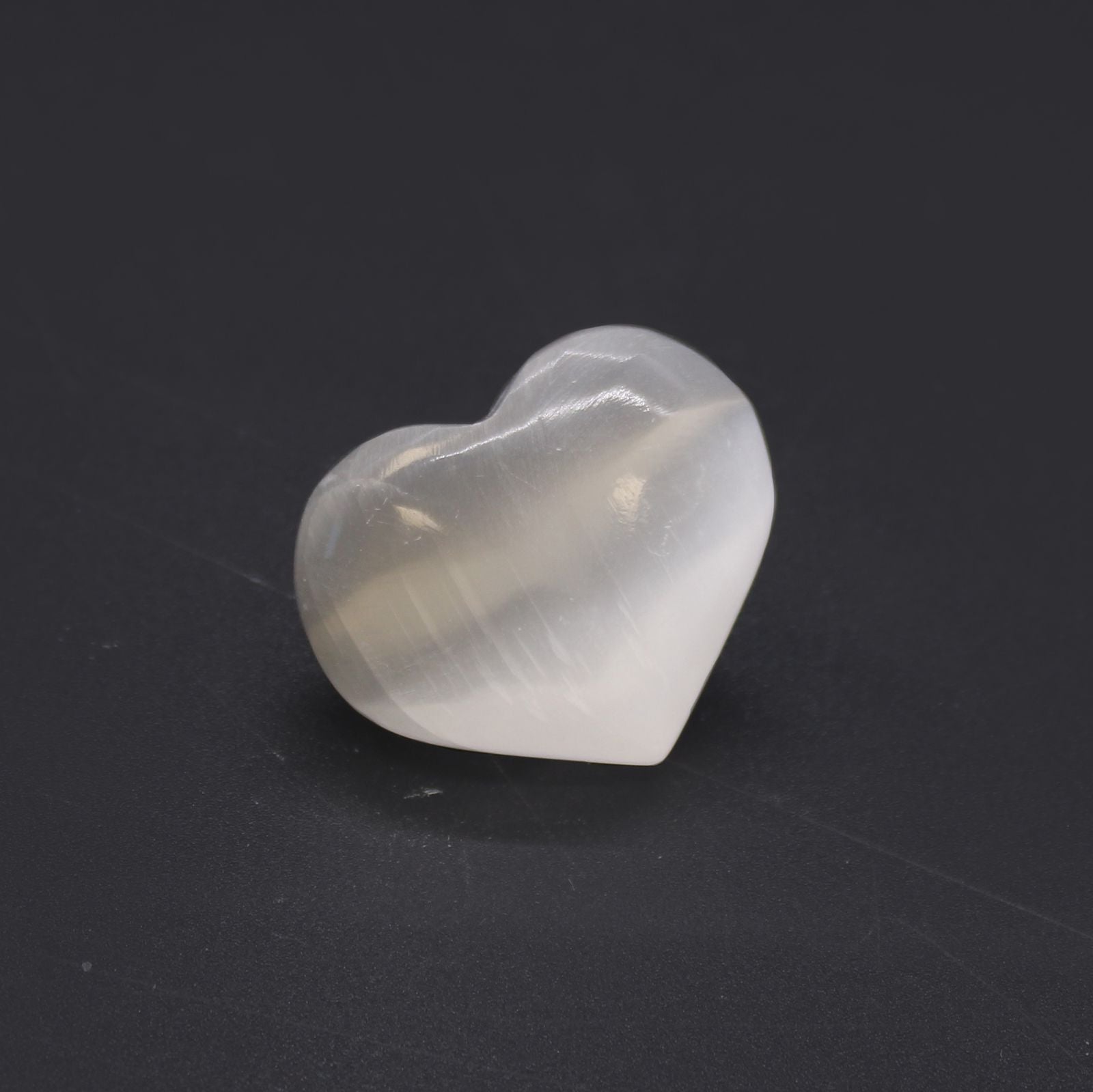 Heart-shaped crystal on a black background
