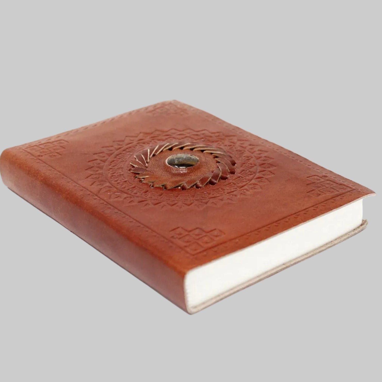 Brown leather notebook with embossed design on a white background