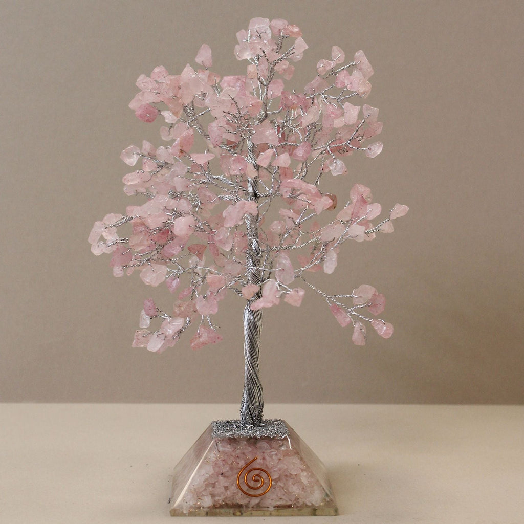 Decorative crystal tree with pink stones on a beige background