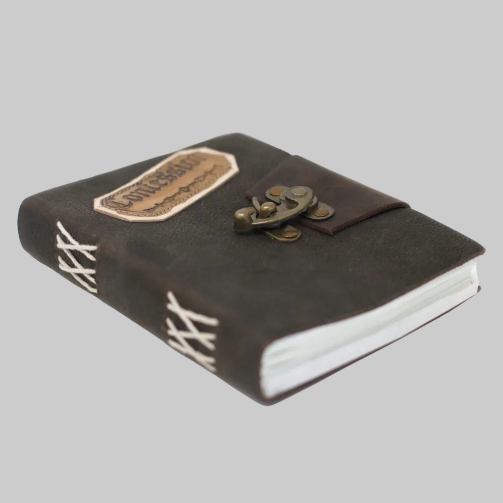 Brown leather notebook with a latch on a white background